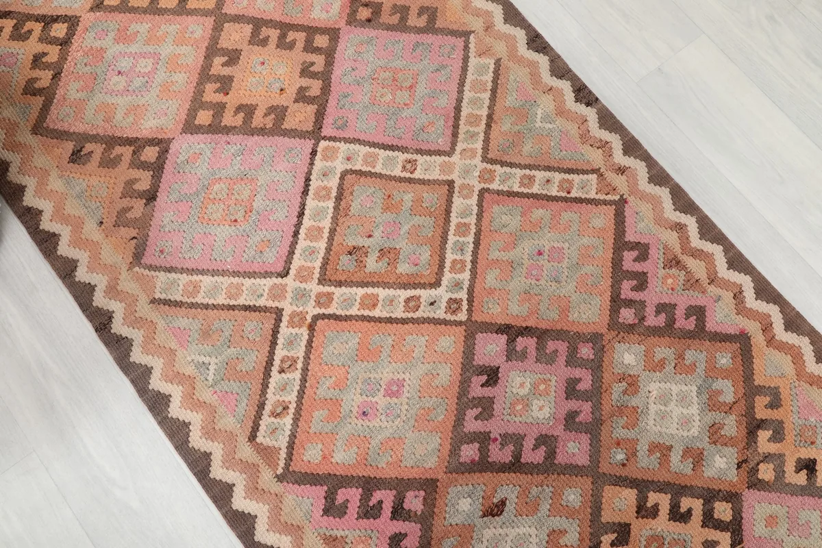 Angled view highlighting the repeating geometric square and diamond patterns across the runner's length.
