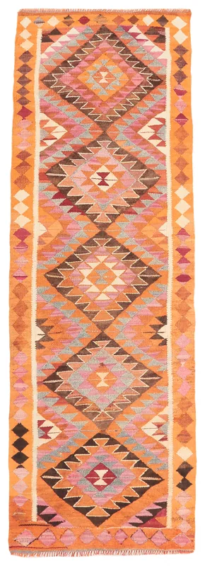 Full top view of the orange, pink, and gray geometric Anatolian runner on a white background