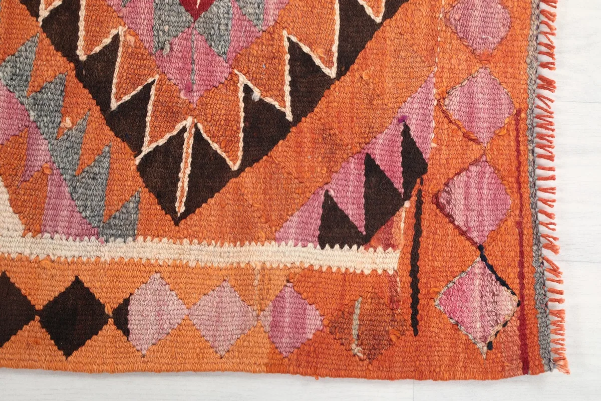 Detailed view of the runner's edge, showing the hand-knotted texture and color variations