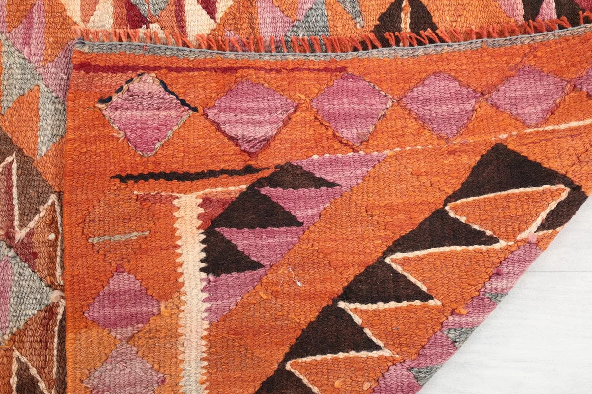 Close-up showing the low pile and texture of the hand-knotted wool