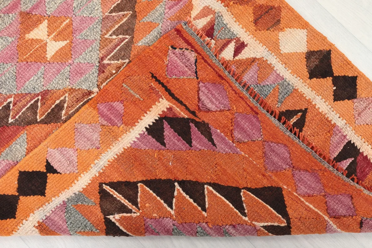 Folded corner revealing the back of the hand-knotted rug and its construction