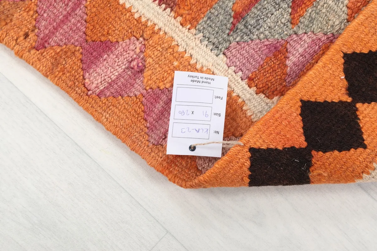 Corner of the runner with a product tag attached, showing authenticity