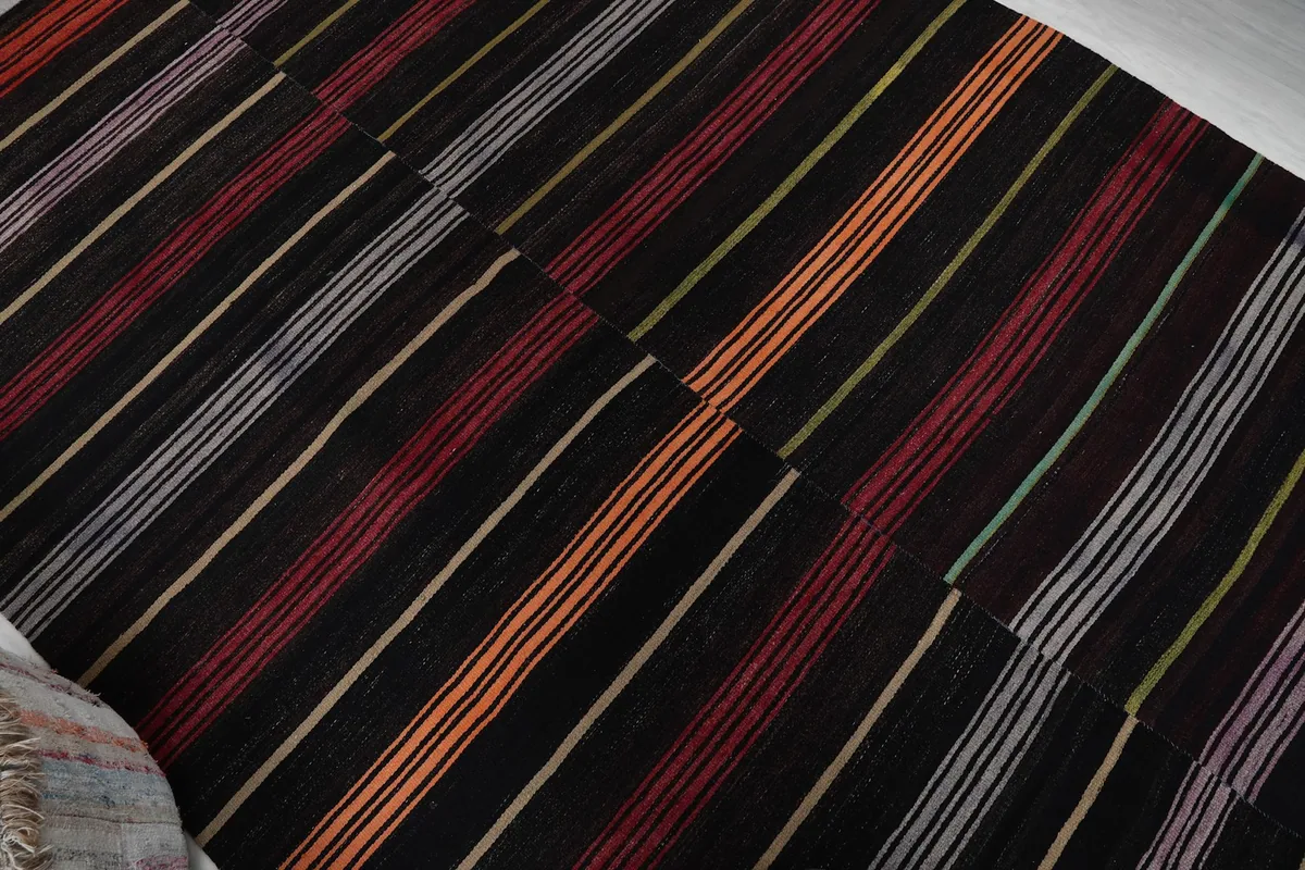 Diagonal view of the striped pattern across the vintage wool rug