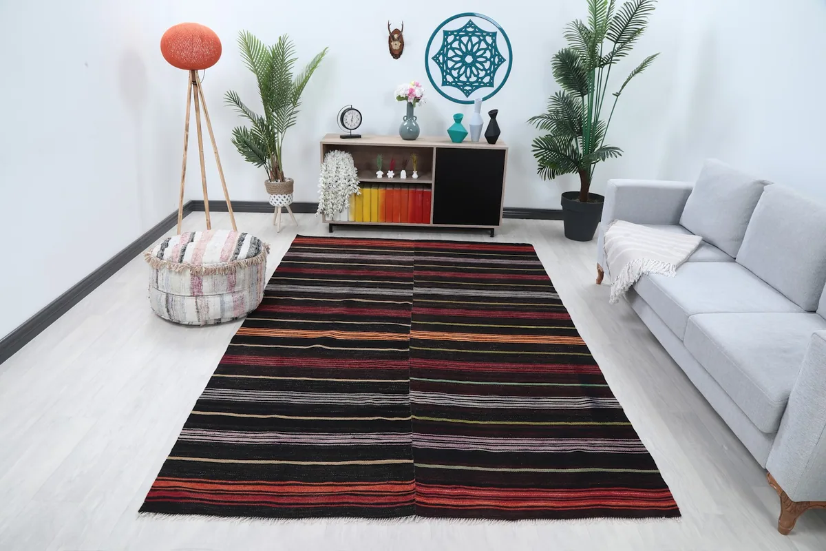 Vintage striped rug displayed in a living room setting with a light gray couch