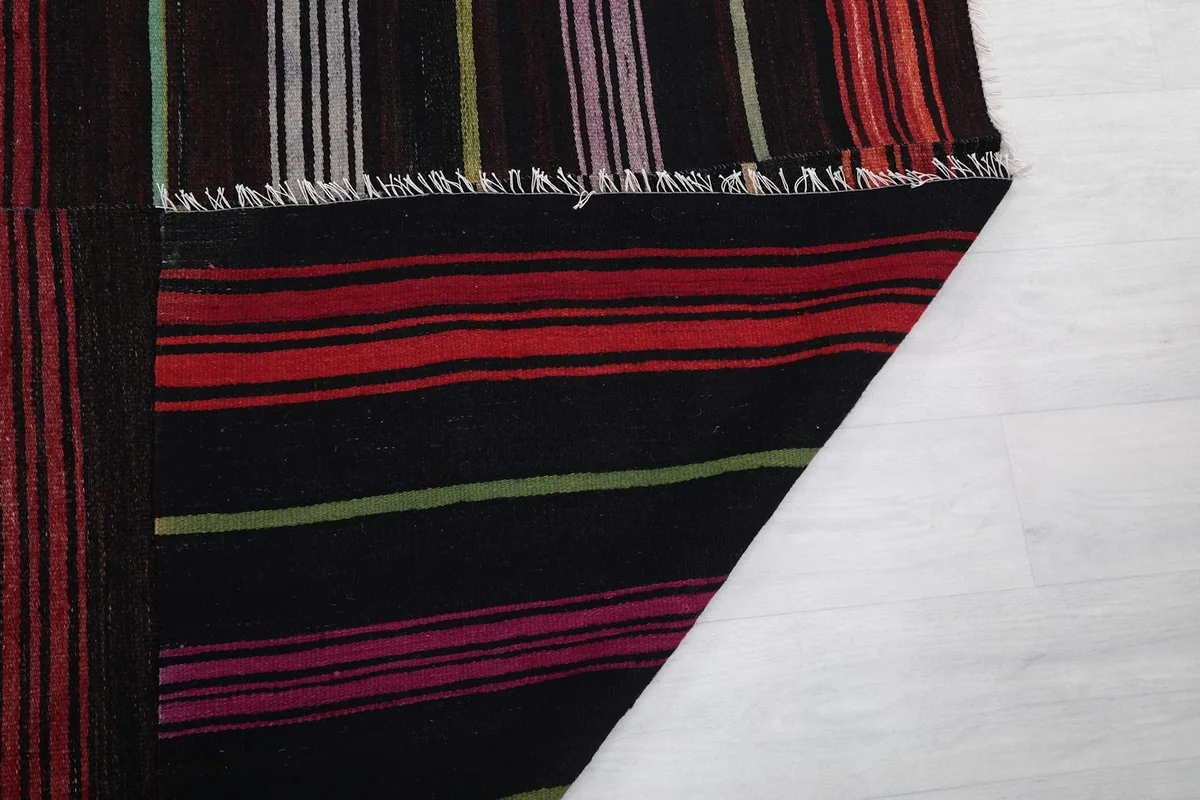 Underside of the rug revealing the cotton foundation and hand-knotted construction