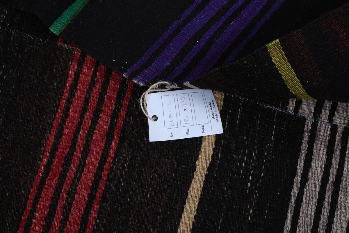 Close-up of the care tag attached to the vintage Anatolian rug