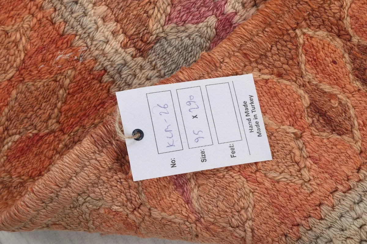 Product tag attached to the rug, displaying its unique ID (KEM-76) and dimensions (95 x 290 cm).