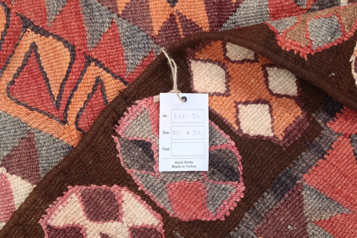 Back of the rug showing the hand-knotted cotton foundation and a tag with rug details.