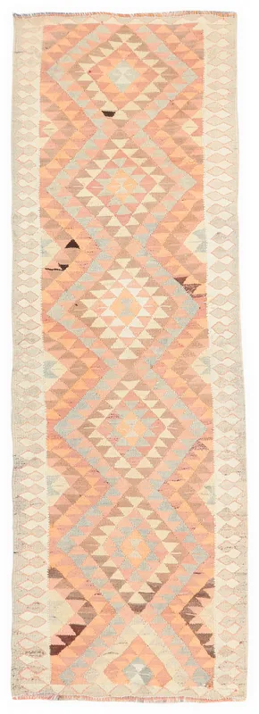 Full overhead view of the orange geometric tribal vintage runner rug on a white background