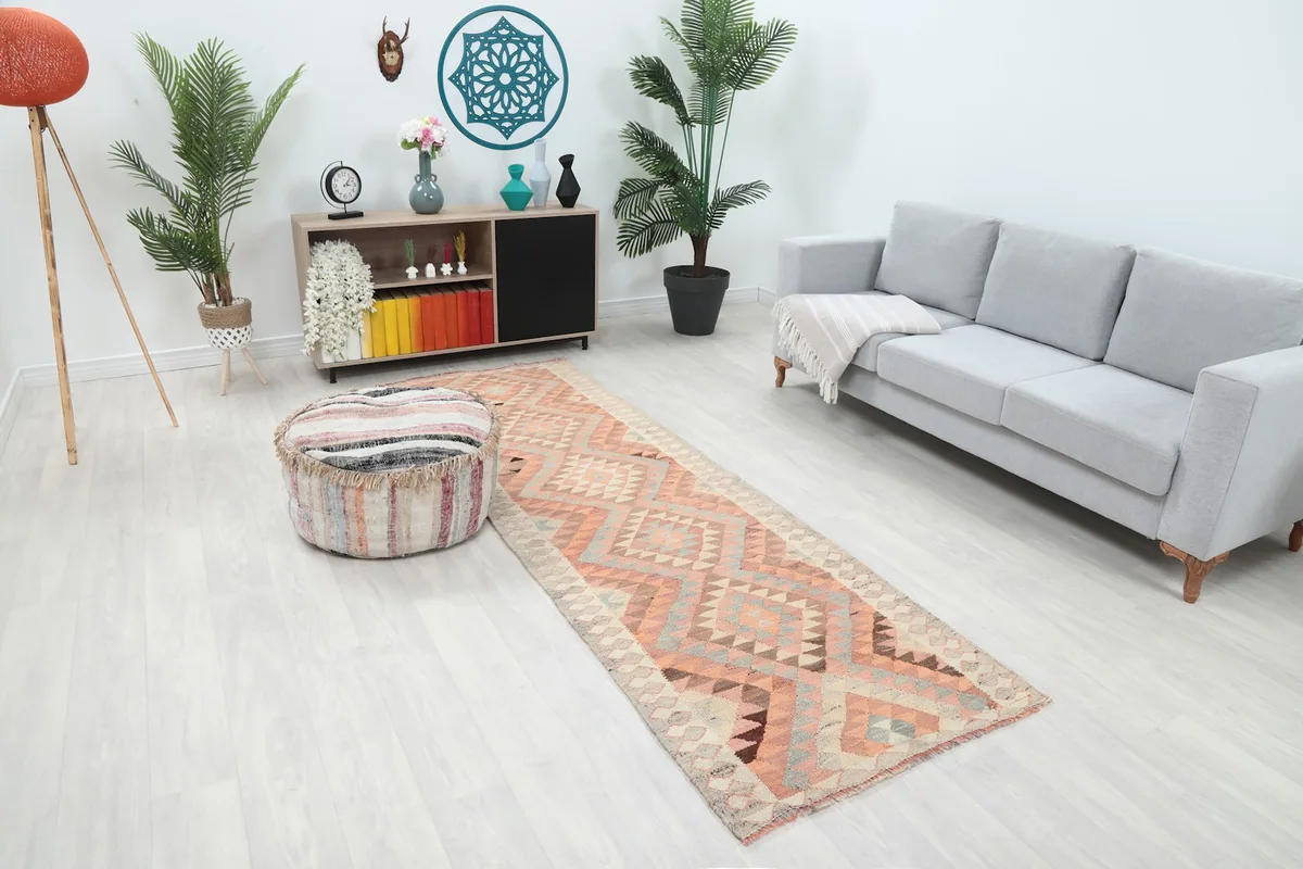 Angle view of the runner rug in a living room, highlighting its placement between furniture