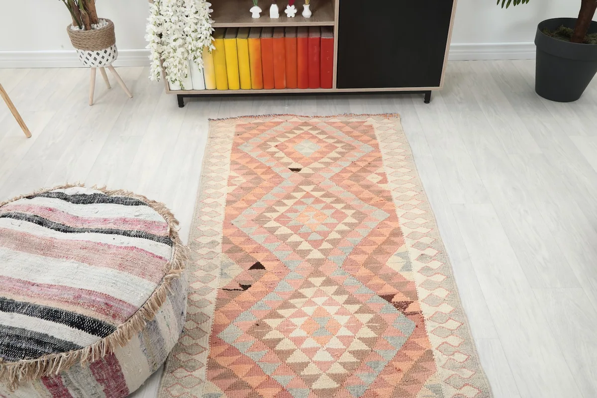 Overhead view of the rug's mid-section, showcasing the repeating diamond motifs and overall design