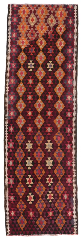 Full top view of the red geometric tribal runner rug on a white background.