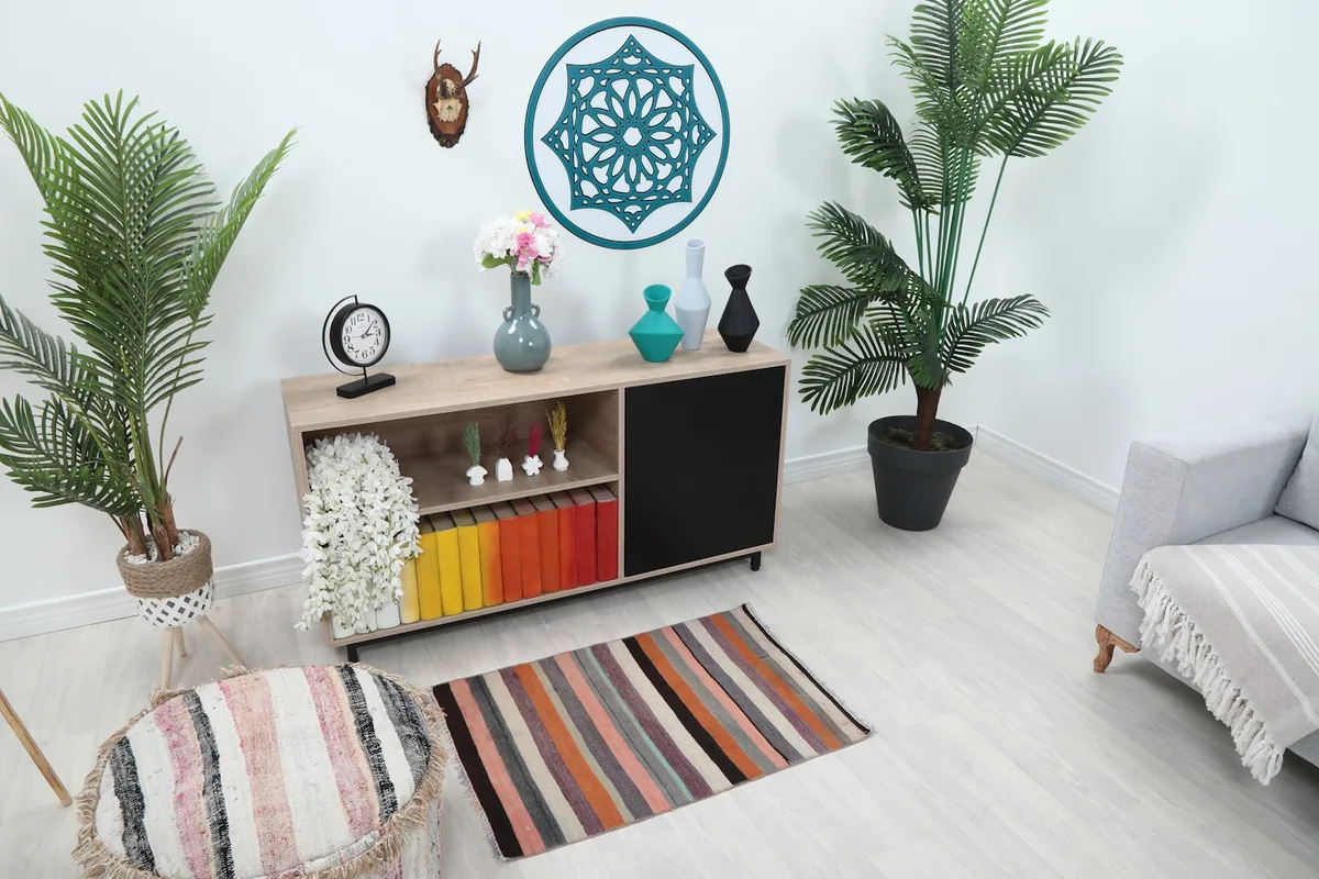 Angle view of the striped rug in a room setting, showing its scale next to furniture