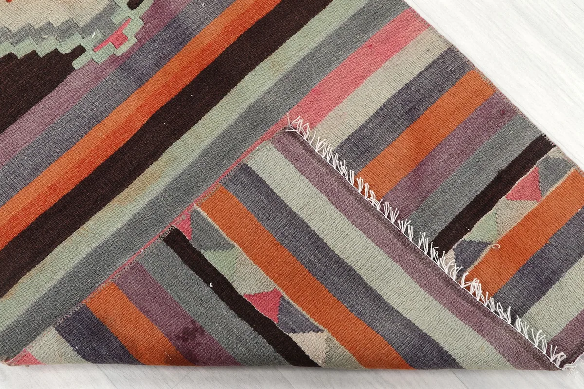 View of the reverse side of the runner, showing the hand-knotted cotton foundation and fringe.