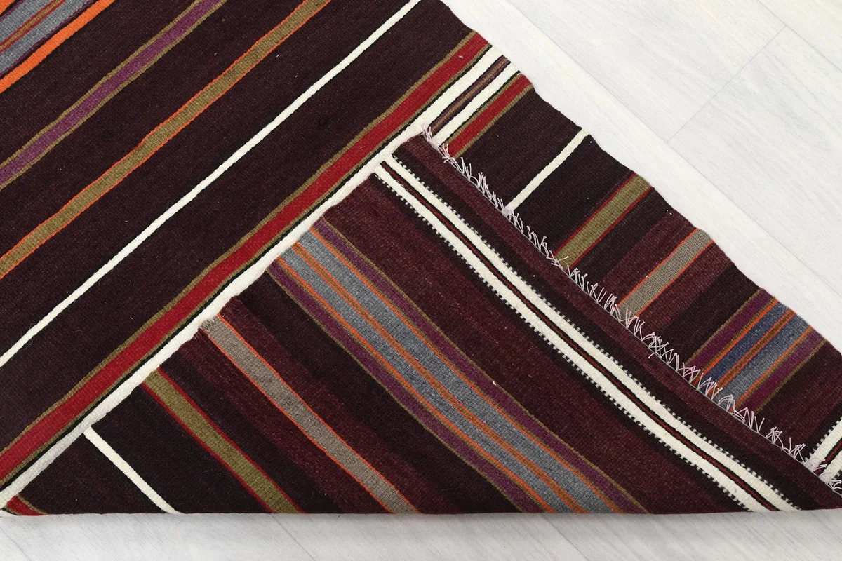 View of the back of the runner rug, revealing the cotton foundation and hand-knotted structure.