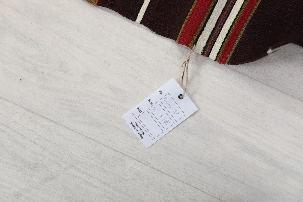 Product tag attached to the runner rug, displaying size and origin information.