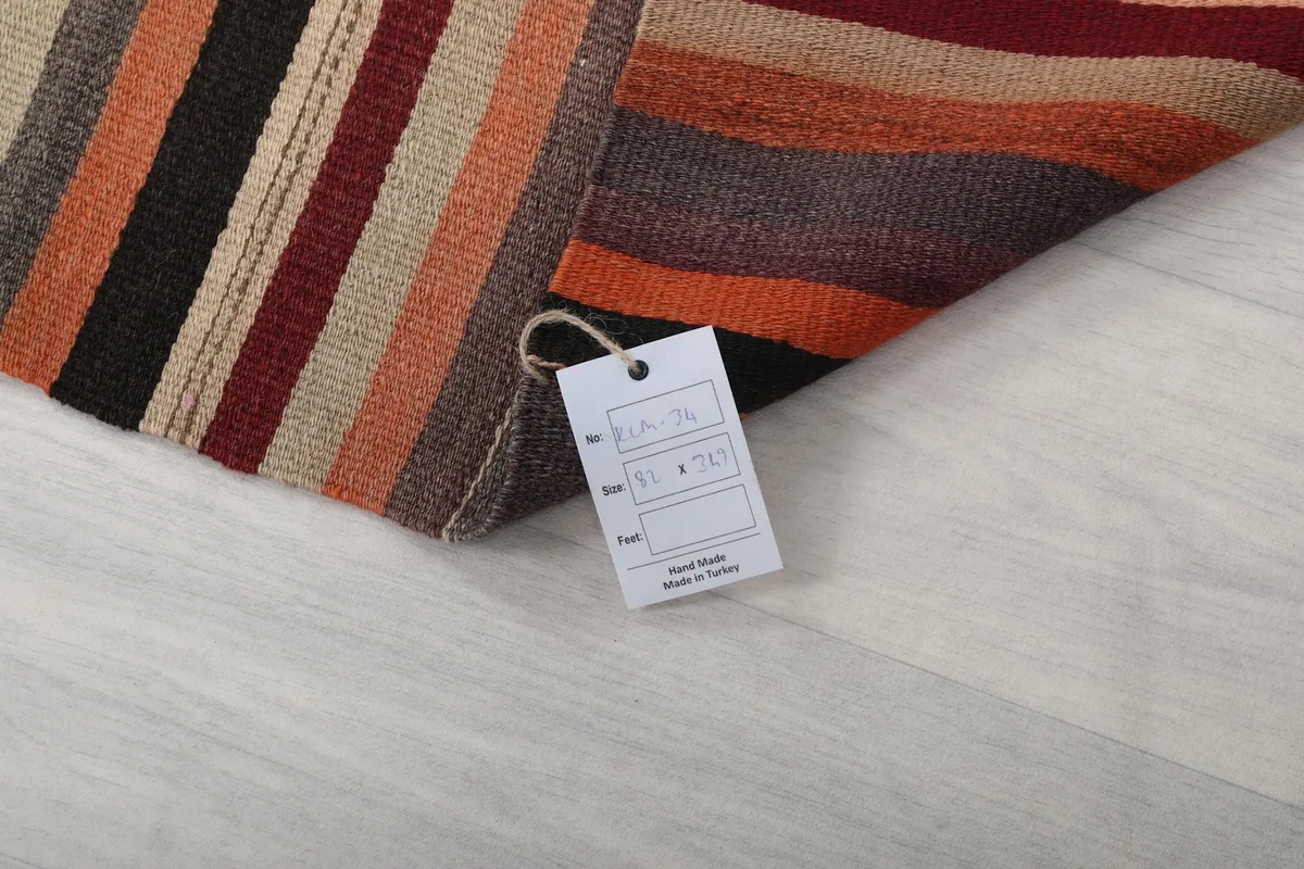 Product tag displaying the rug's size and origin, resting on the folded rug