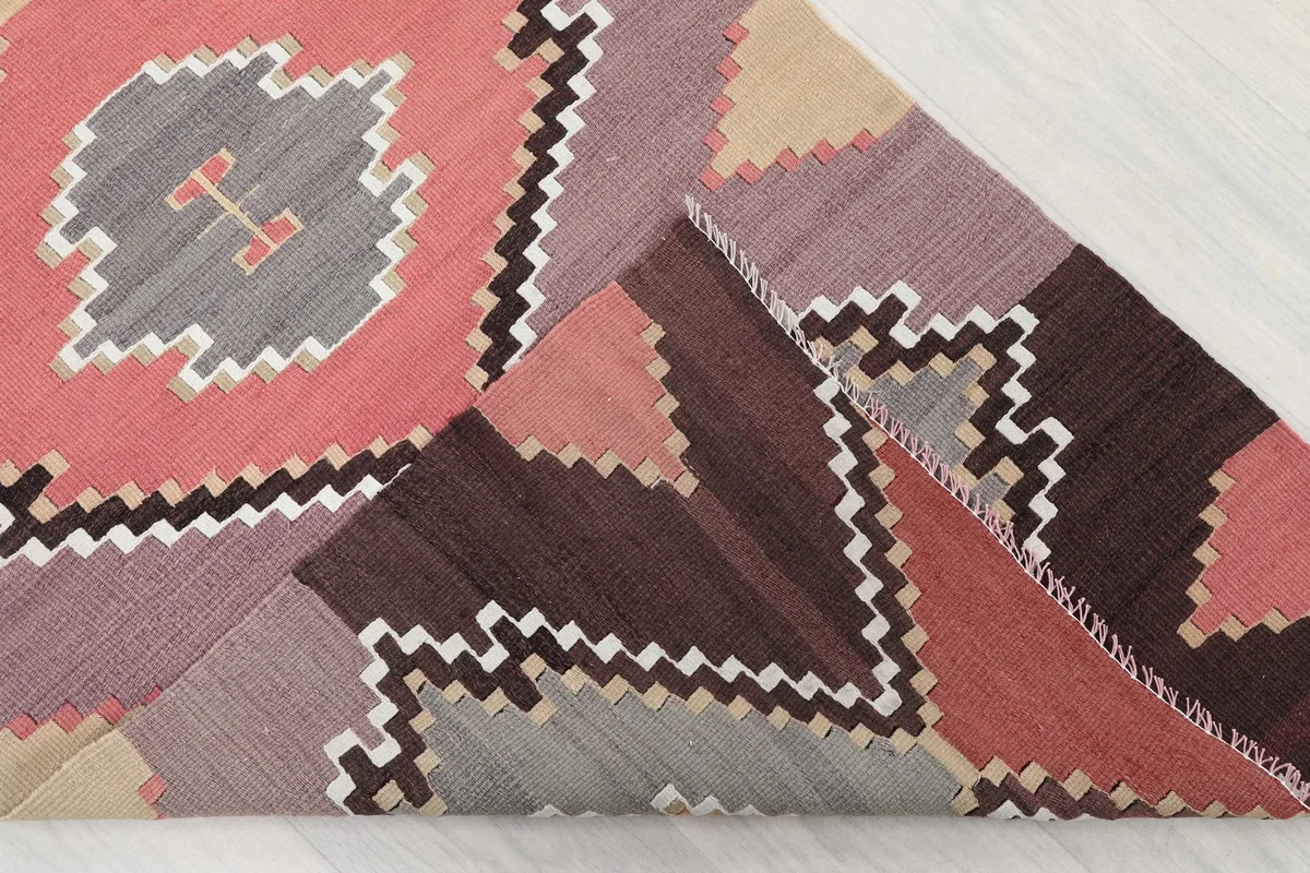 Folded section of the runner, revealing the hand-knotted construction and varied color blocks