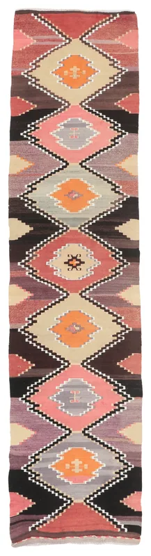 Full overhead view of the vintage Anatolian runner rug with geometric pink, orange, and beige patterns.