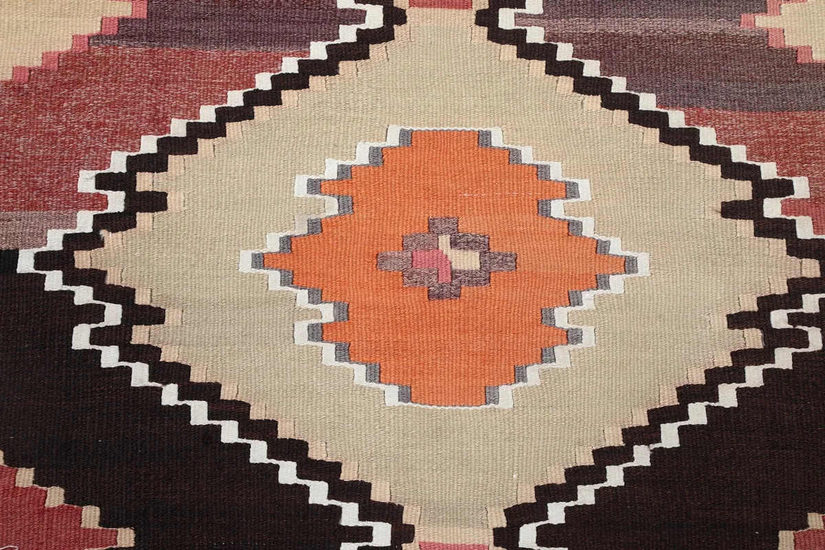 Central detail of a large beige diamond with an orange center motif, surrounded by other colors.