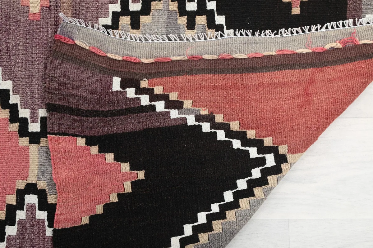 Another folded view of the rug, showing the reverse side and the hand-knotted details.