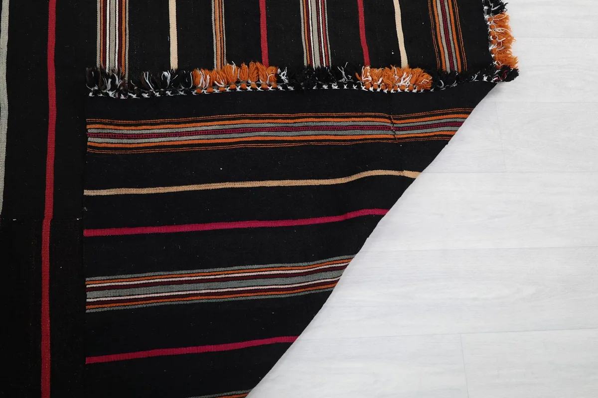 Close-up of the rug's back and foundation, showing hand-knotted construction