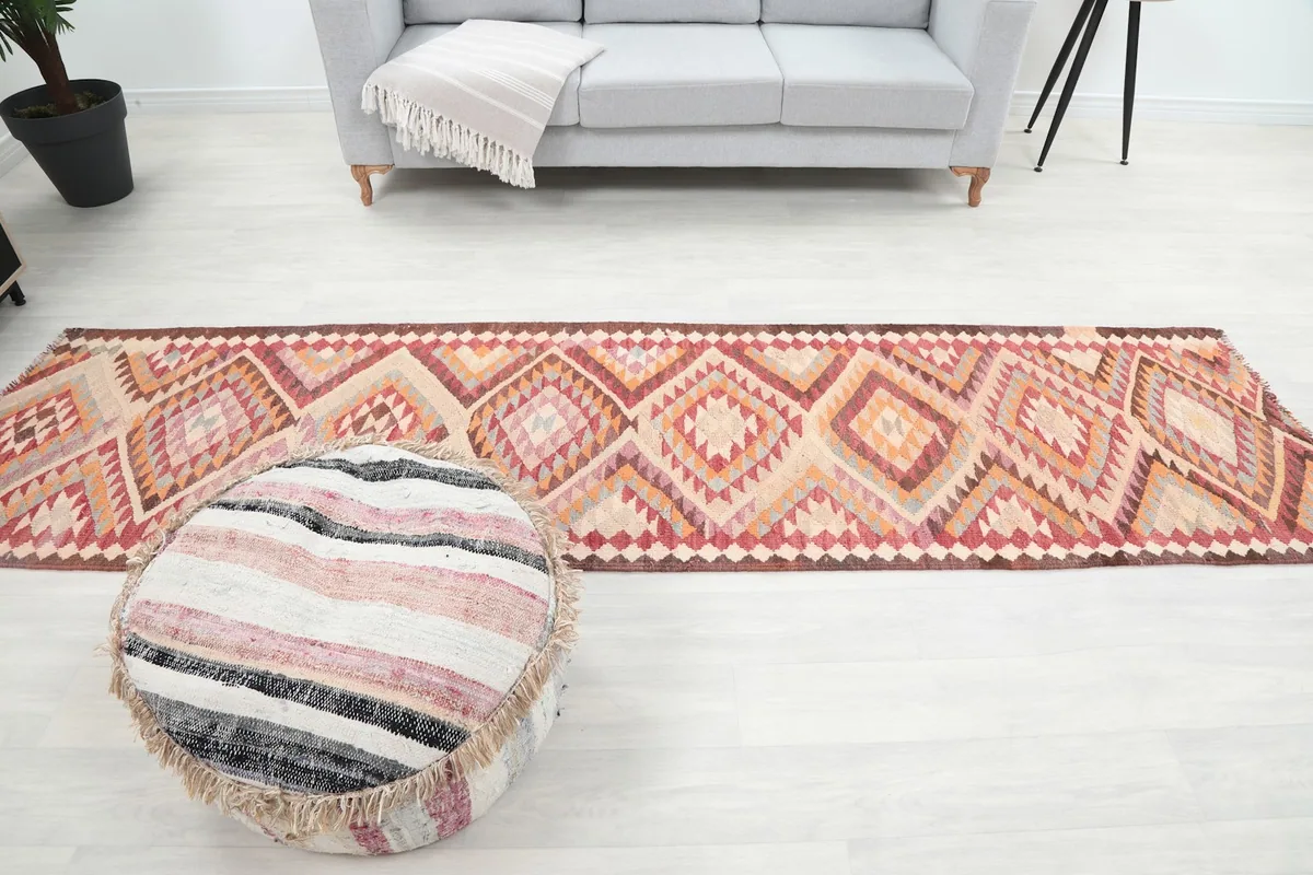 Wide shot of the runner rug laid out in the living room, showing its scale relative to furniture
