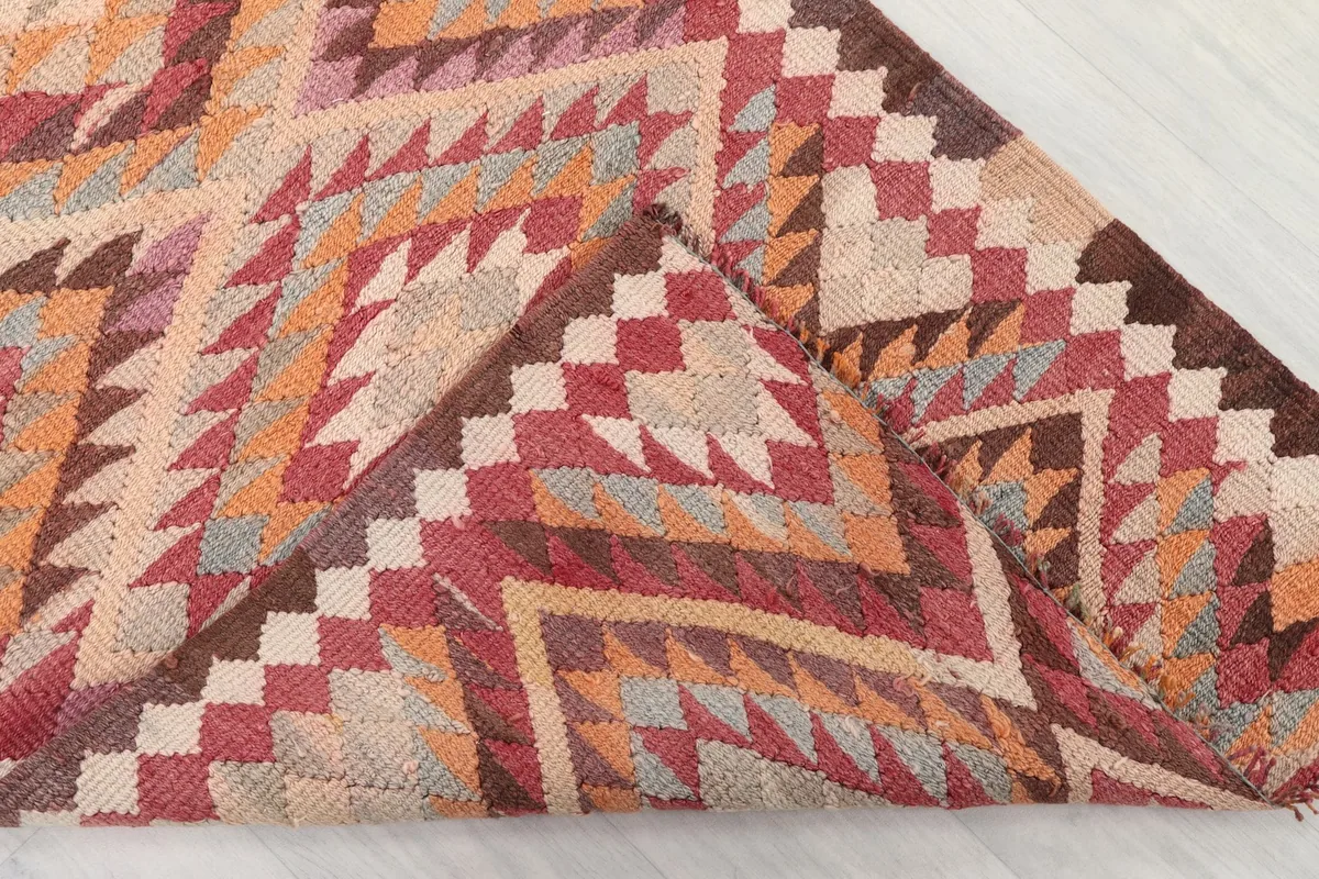 Folded corner of the rug, displaying the density of the weave and the back of the hand-knotted construction