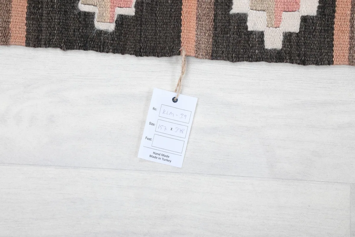 Product tag attached to the rug, displaying details like size and origin