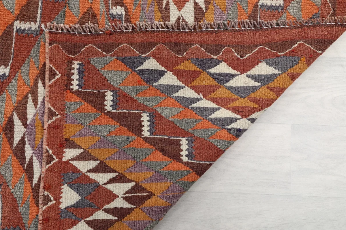 View of the back of the rug, showing the tight hand-knotted cotton foundation and wool knots.