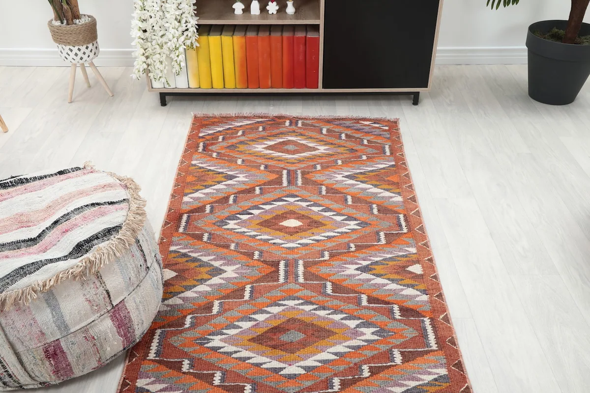 Overhead view of the vintage runner rug in a room, showing its full pattern and placement.