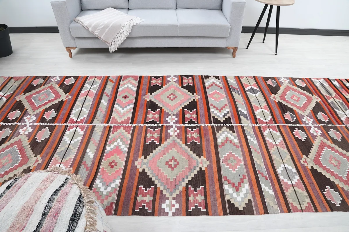 Room shot from the end of the rug, looking towards a gray sofa