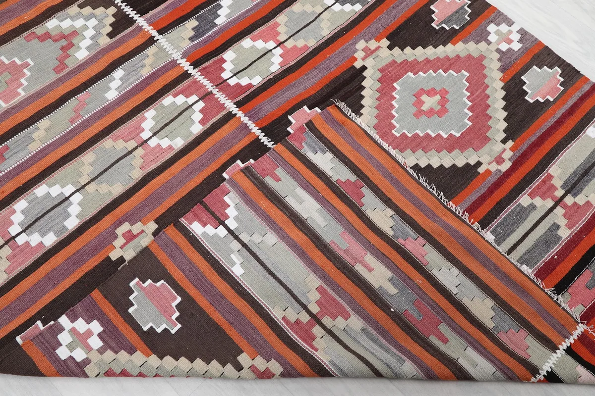 Folded corner of the rug revealing the thickness of the low pile and color variations