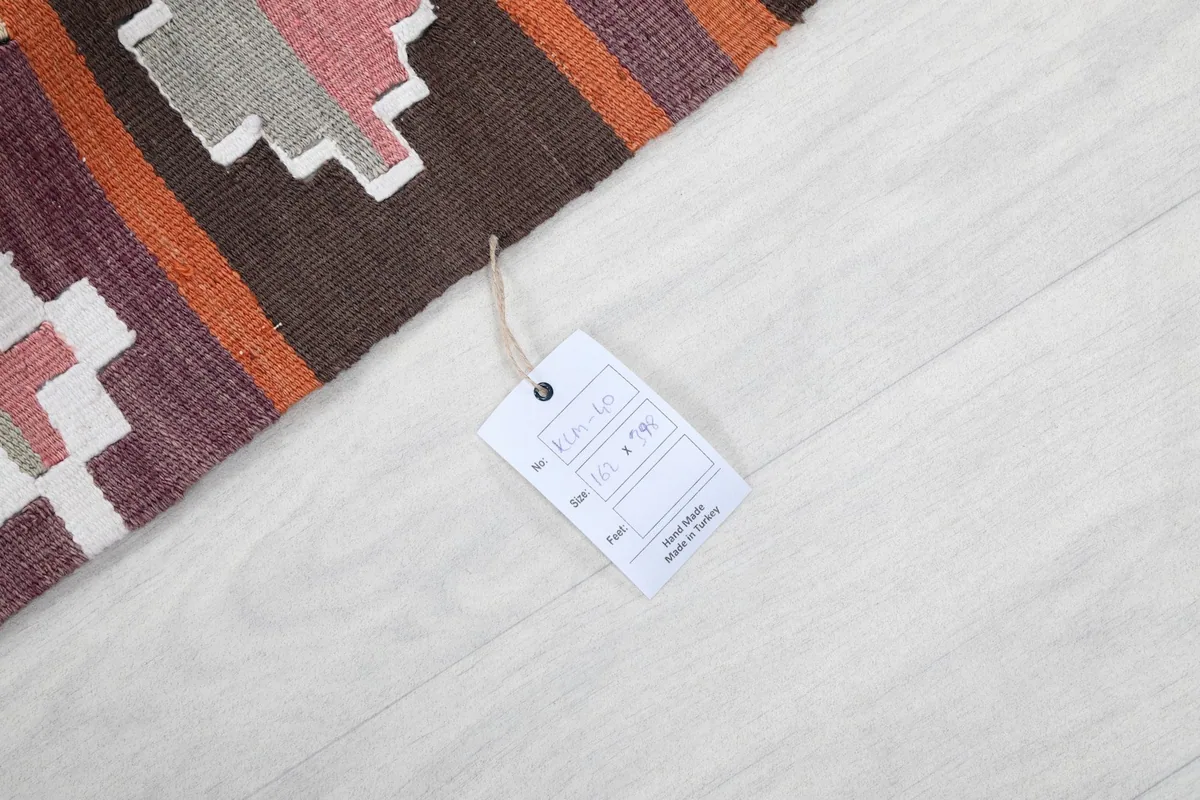 Close-up of the rug with a product tag, indicating its origin and material