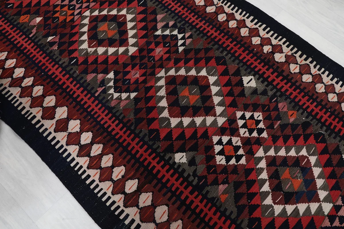 Angled view highlighting the varied geometric shapes and color transitions in the rug