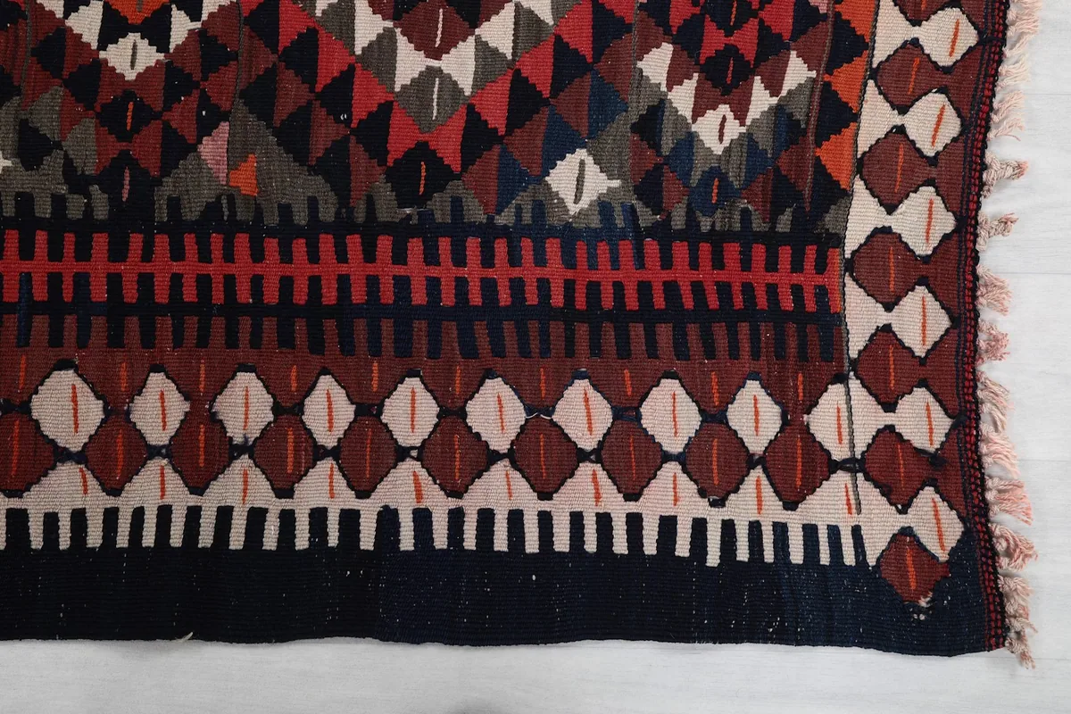 Detailed view of the border and central geometric motifs of the hand-knotted runner