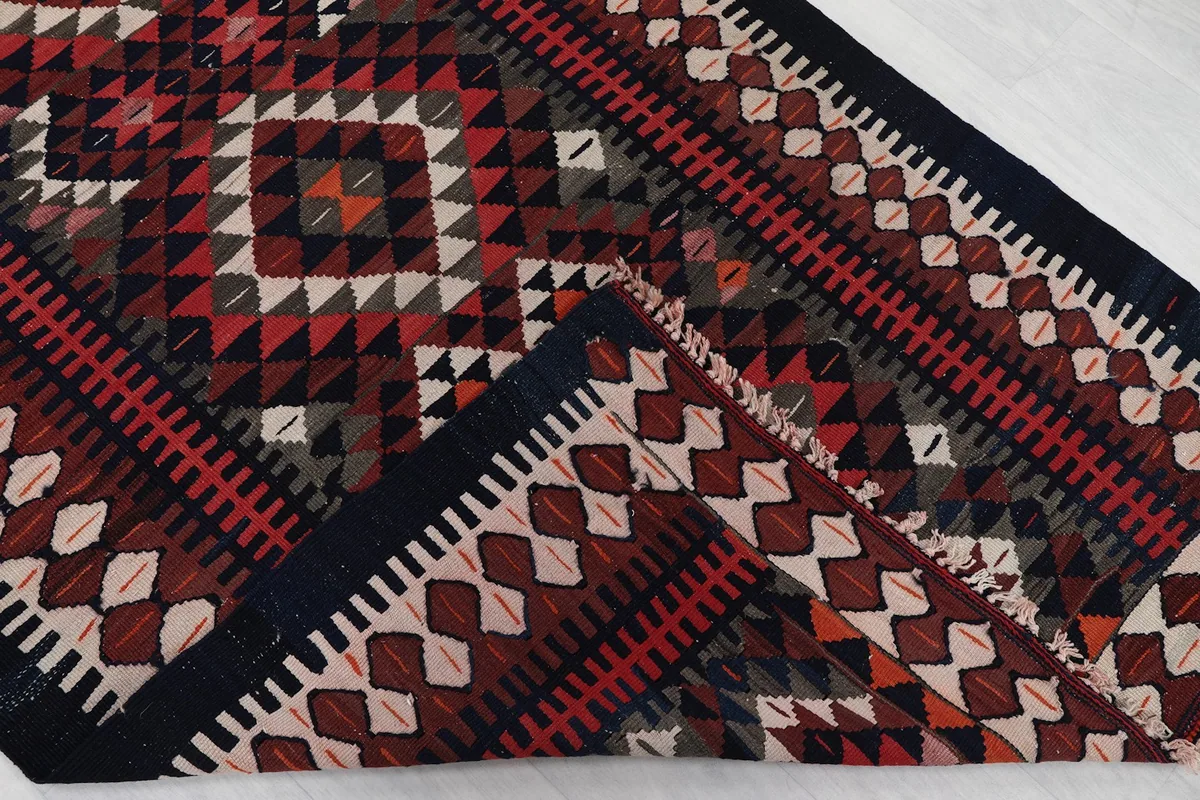 Folded corner of the rug, showing the wool pile texture and hand-knotted construction