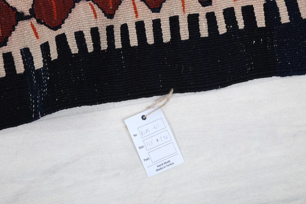 Close-up of the rug's label indicating it is hand-made in Turkey