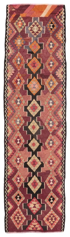 Full top view of the vintage rust and black geometric Anatolian runner rug on a white background