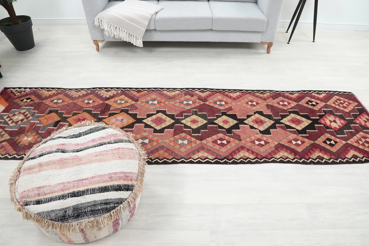 Full length view of the runner rug in a room, extending from a sofa towards the foreground