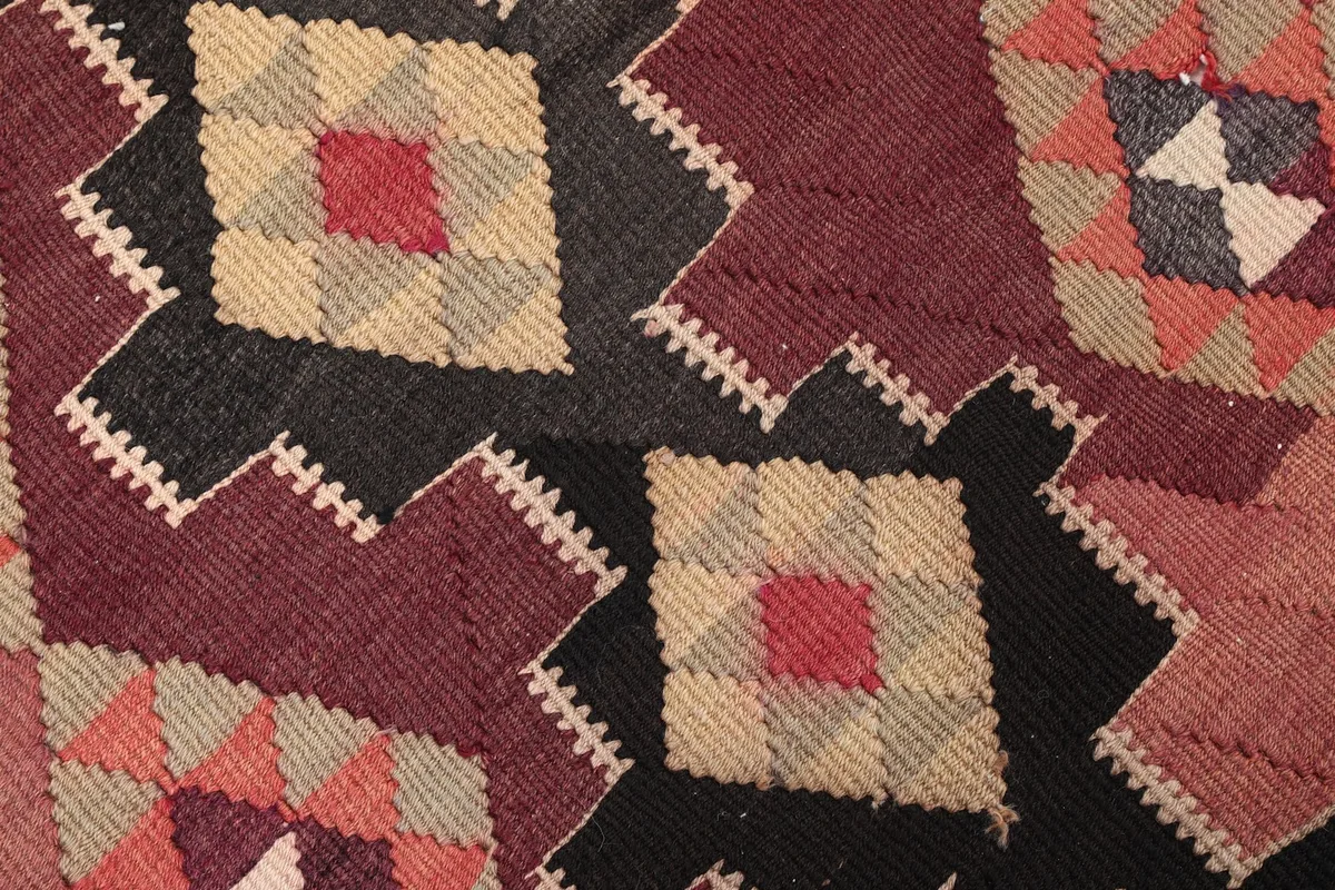 Close-up of the wool pile showing individual knots and texture within the geometric design