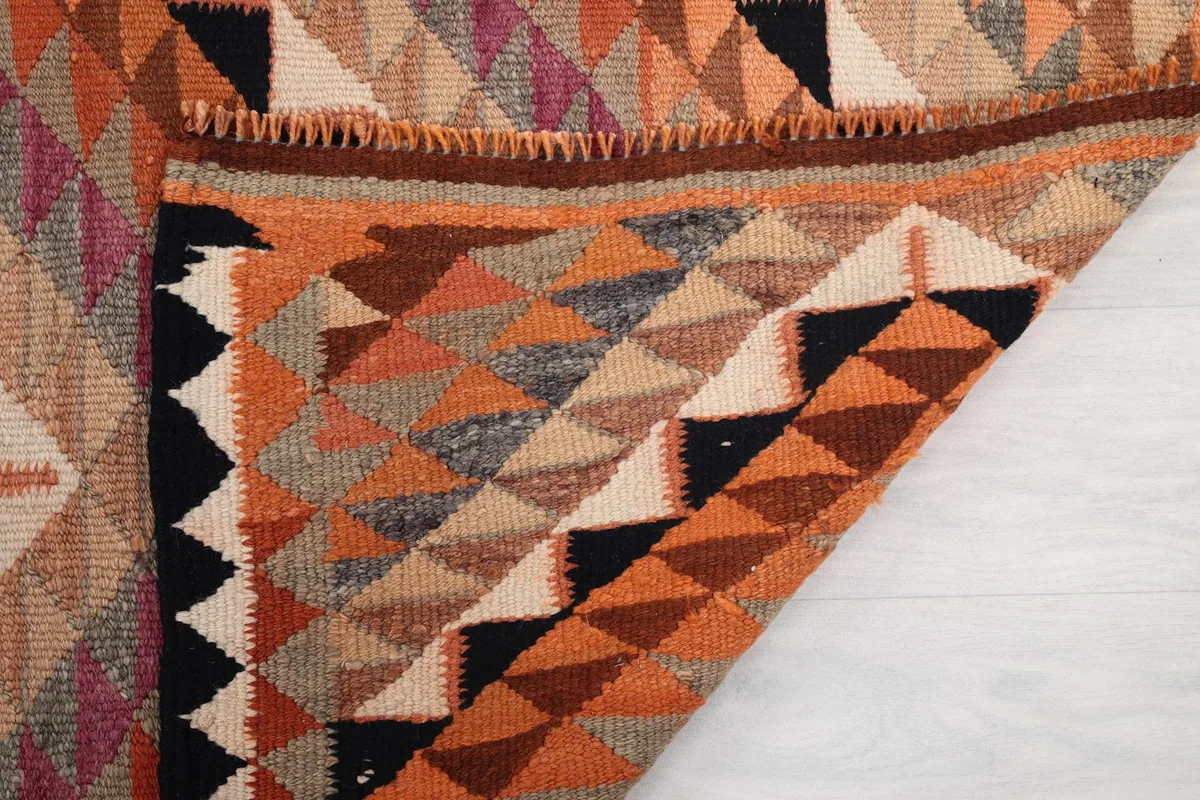 Underside and folded edge of the rug, showing the hand-knotted construction