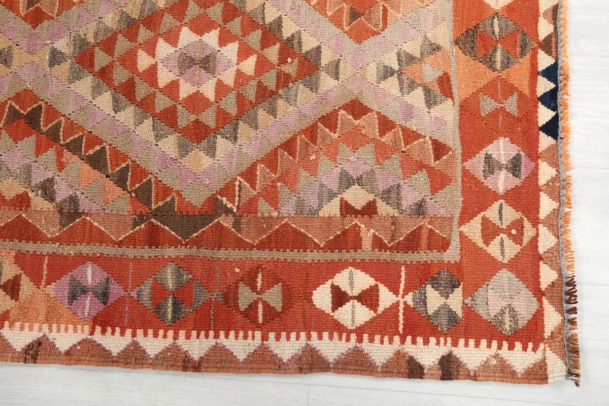 Detailed view of the orange border and a section of the main tribal pattern