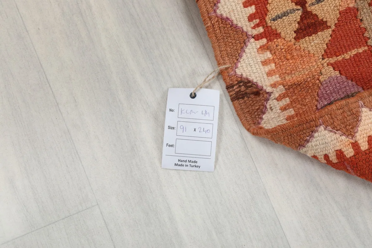 Product tag on the rug, indicating its size and origin as hand-made in Turkey