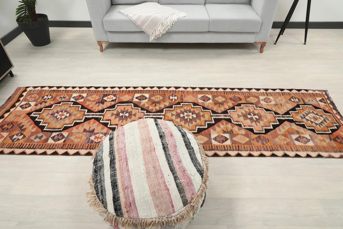 Overhead room view of the long runner rug placed in front of a light gray sofa