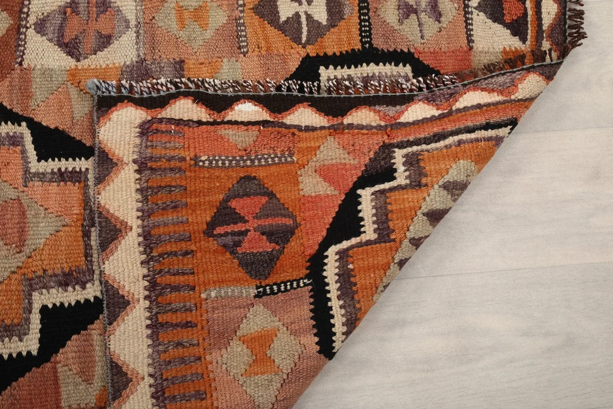 Underside and edge of the rug, showing the hand-knotted construction and fringe