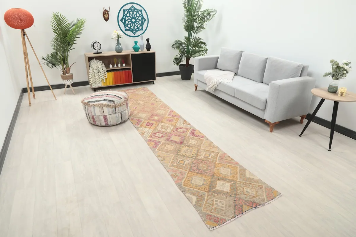 Long view of the beige and rose geometric runner rug extending through a modern living space