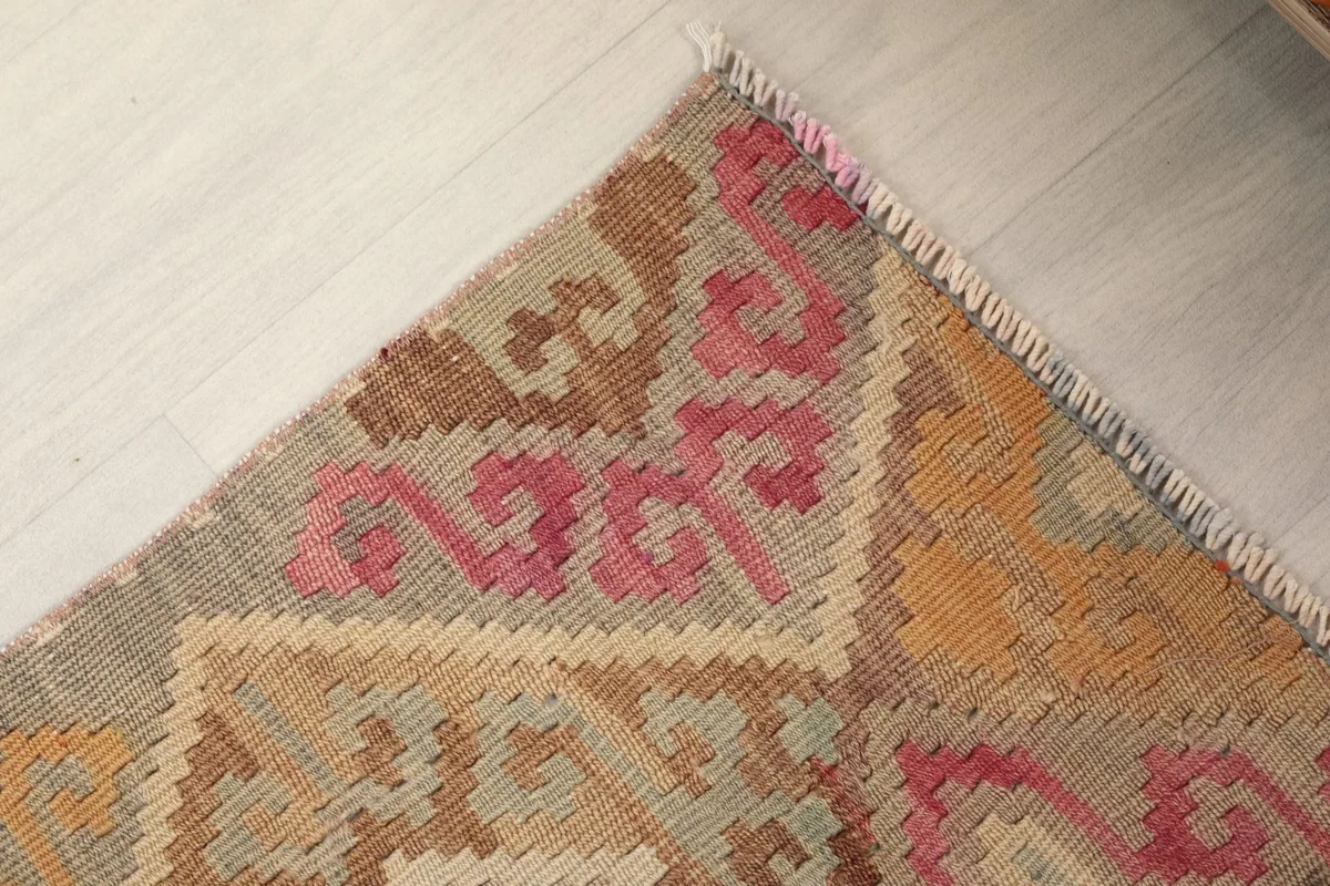 Corner detail of the runner rug, highlighting the geometric border and fringe