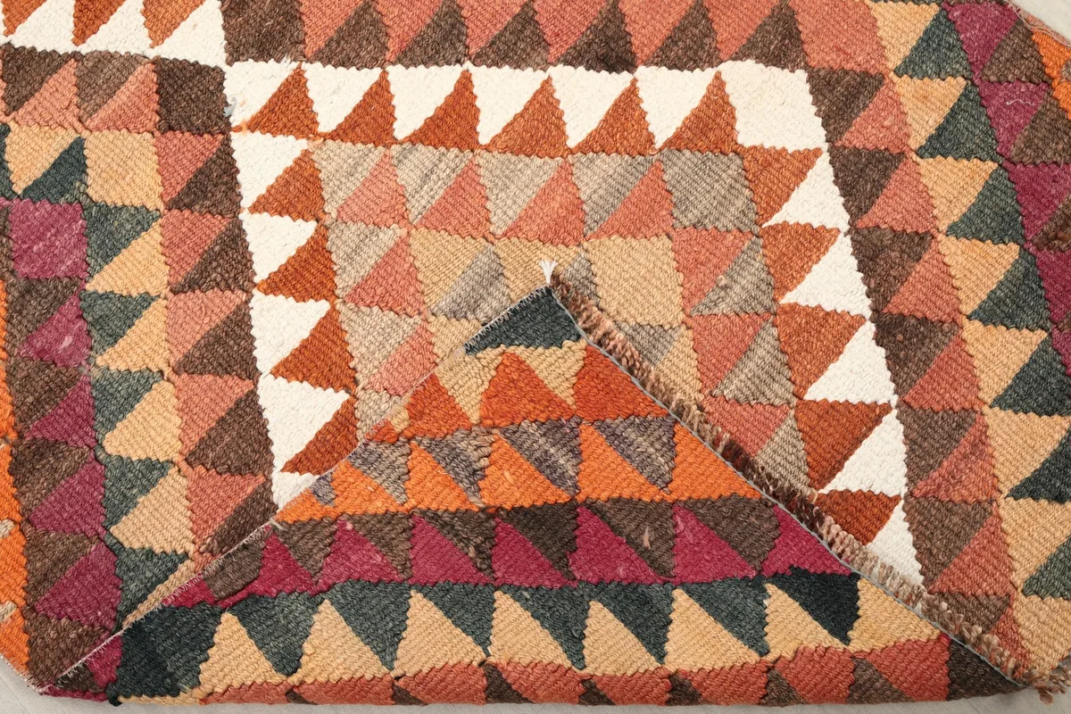View of the back of the rug, showing the cotton foundation and hand-knotted construction.