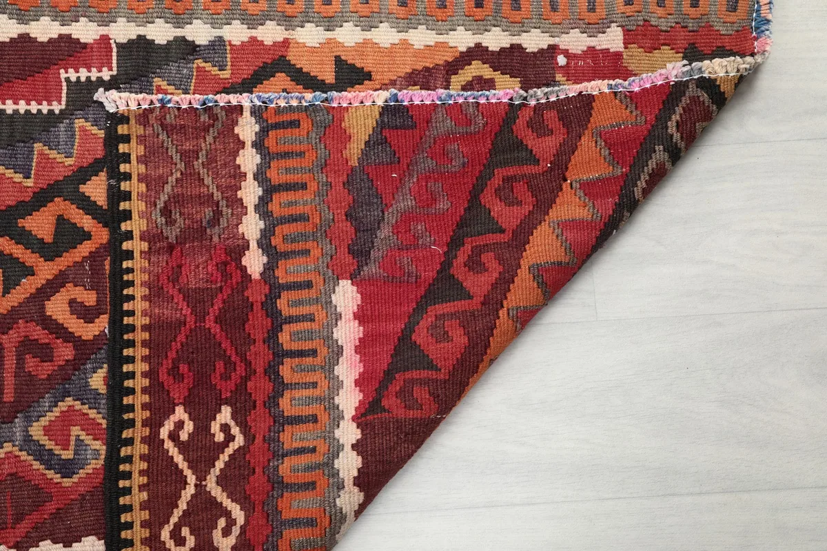 Another view of the rug's underside, revealing the tightly woven cotton foundation and knot structure.